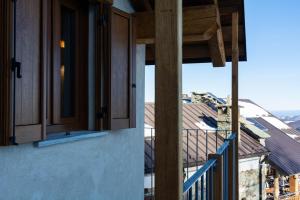a balcony with wooden cabinets and a view of a building at Chalet Burrino in Frabosa Soprana +2 photos