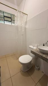 a white bathroom with a toilet and a sink at Casa Colina in Ouro Preto +38 photos