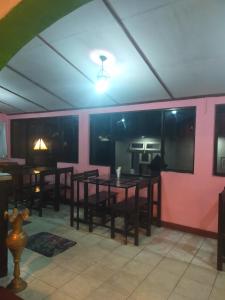 a dining room with tables and pink walls at Cool feel rest and cafe in Nuwara Eliya