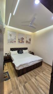 a bedroom with a large bed and a ceiling at Hotel MRK VILLA in Varanasi +31 photos