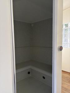 a walk in shower with a glass door at Studio-Guest House with Jacuzzi Spa and Sauna in Espartinas