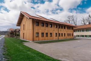 a large wooden building with a lot of windows at StadlTraum Falkenberg in Moosach