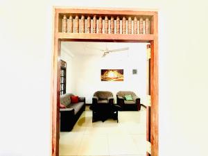 a living room with a couch and a table at Long Beach Homestay in Tangalle