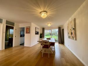 a living room with a table and a dining room at Spacious 4-Bed Home in Ascot in Ascot