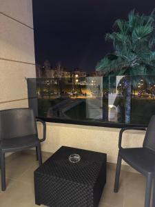 two chairs and a table in front of a window at Centrico 10 Confort & Luxe au Centre in Tangier