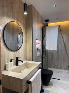 a bathroom with a large sink and a mirror at Centrico 10 Confort & Luxe au Centre in Tangier +8 photos