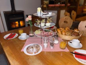 a table topped with plates of food and bread at StadlTraum Falkenberg in Moosach