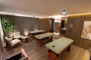 a waiting room with tables and chairs in a room at Zi One Luxury Hotel in Pereira +39 photos