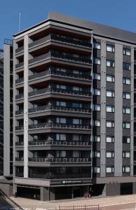 a large apartment building with balconies at KIORI Exec Gojo in Kyoto