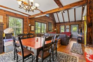 a dining room and living room with a table and chairs at Knotty By Nature- Pet Friendly, Firepit, 150 Acres in Campton
