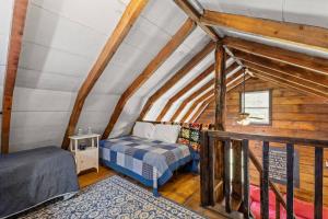 a bedroom with two beds in a attic at Knotty By Nature- Pet Friendly, Firepit, 150 Acres in Campton