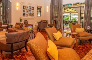 a lobby with couches and chairs and a table at Cozy Stead Hotel - Garden House, Gigiri in Nairobi