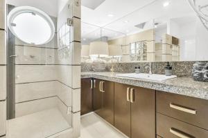 a bathroom with a shower and a sink at The OceanFront Private Residence in La Paz