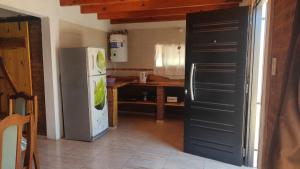 a kitchen with a refrigerator and a table at Dúplex para 4 San Luis in Barranca Colorada