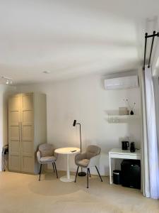 a room with two chairs and a table and a desk at Residenza Marrone in Montefalco