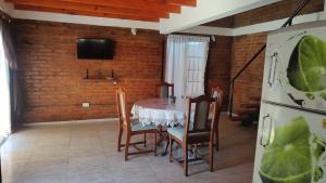 a dining room with a table and chairs and a tv at Dúplex para 4 San Luis in Barranca Colorada