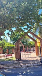a brick archway in a park with a fence at Casa AMBAR in Concordia