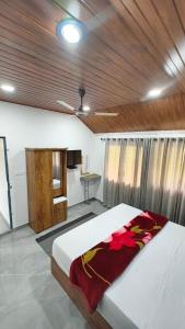 a bedroom with a large bed with a wooden ceiling at Hang on in Anachal