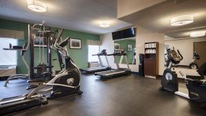 a gym with several tread machines in a room at Best Western O'Hare/Elk Grove Hotel in Elk Grove Village