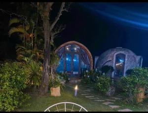 a lit up yard with two domes at night at Mũi Si Homestay Cửa Tùng in Vĩnh Bang +28 photos