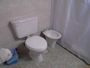 a bathroom with a toilet and a sink at Los Fresnos in El Calafate +44 photos