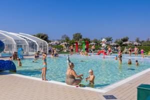 a group of people in a swimming pool at Camping Village Capalonga in Bibione