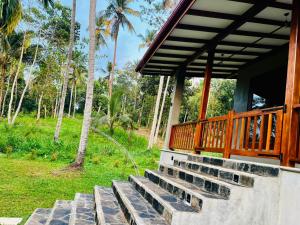 a set of stairs leading to a porch of a house at Villa Stillrock in Dodanduwa