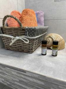 two baskets sitting on a bench with two bottles at Charming Spetses Studio with Outdoor Space in Spetses