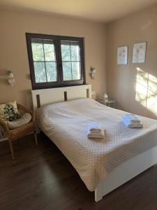 a bedroom with a large bed with towels on it at Vila Lucic Zlatibor in Zlatibor