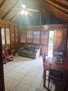 a living room with a couch and a table at Negril Humble Cabin in Negril