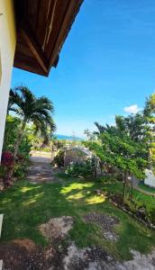 a view from the porch of a house with palm trees at Negril Humble Cabin in Negril