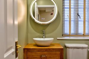 a bathroom with a bowl sink and a mirror at Finest Retreats - The Kiln in Bamburgh +17 photos