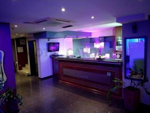 a room with purple lighting and a large fireplace at Carol Hotel in Piraeus