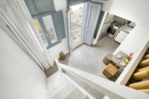 an overhead view of a kitchen and stairs in a house at Mykonos Yialos Town Home Loft - by Hospirit in Mikonos +11 photos