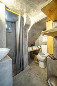 a bathroom with a sink and a toilet at Mykonos Yialos Town Home Loft - by Hospirit in Mikonos