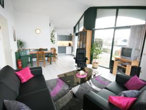 a living room with a couch and a table at Aquaronde 129 in Lemmer