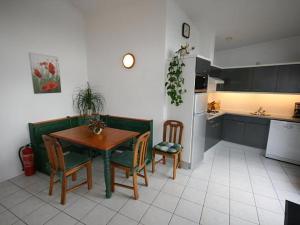 a kitchen and dining room with a table and chairs at Aquaronde 129 in Lemmer +4 photos