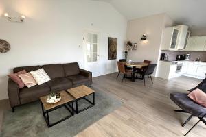 a living room with a couch and a table at Aquaronde 122 in Lemmer