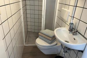 a bathroom with a toilet and a sink at Aquaronde 122 in Lemmer +14 photos