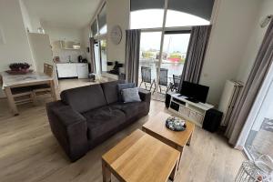 a living room with a couch and a table at Aquaronde 120 in Lemmer