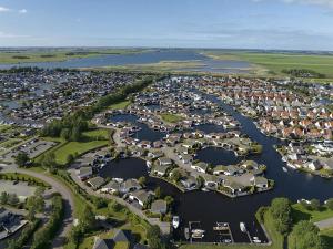 an aerial view of a harbor with houses and water at Aquaronde 120 in Lemmer
