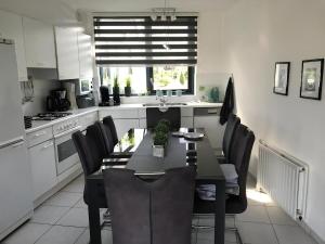 a kitchen with a dining room table and chairs at Park Brekkense Wiel 058 in Lemmer