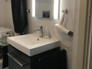 a bathroom with a white sink and a mirror at Park Brekkense Wiel 058 in Lemmer +9 photos