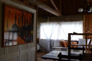 a living room with a couch and a window at Aldeia Santuario das Aves in Tavares
