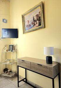 a room with a table with a lamp and a painting on the wall at Mary's apartment Elaia 3 in Elia Laconias