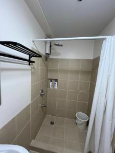 a bathroom with a shower with a toilet and a shower curtain at Celeste Stays- Celandine in Sampong