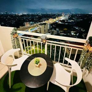 a table and chairs on a balcony with a view at Celeste Stays- Celandine in Sampong