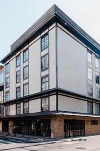 an external view of a large building with a large billboard at KIORI Exec Muromachi in Kyoto