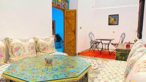 a living room with a couch and a table at Dar Fayrouz in Fez