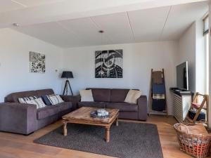 a living room with a couch and a coffee table at Park Brekkense Wiel 069 in Lemmer